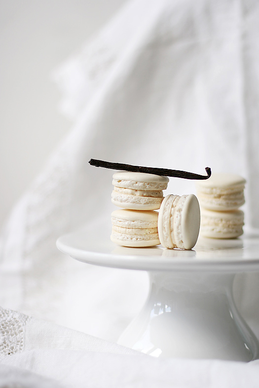 five macarons piled on w white container