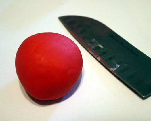 smooth red ball of fondant and cut it into the body of the tractor